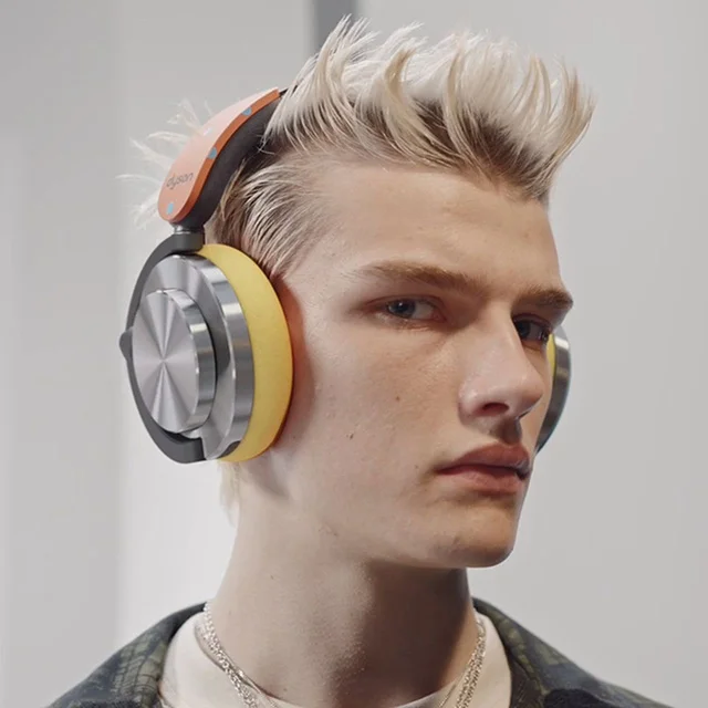 A model wearing Dyson OnTrac headphones in custom color combo