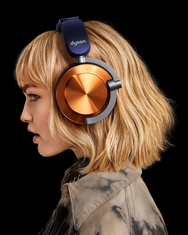 A model wearing Dyson OnTrac headphones in CNC Copper color combo