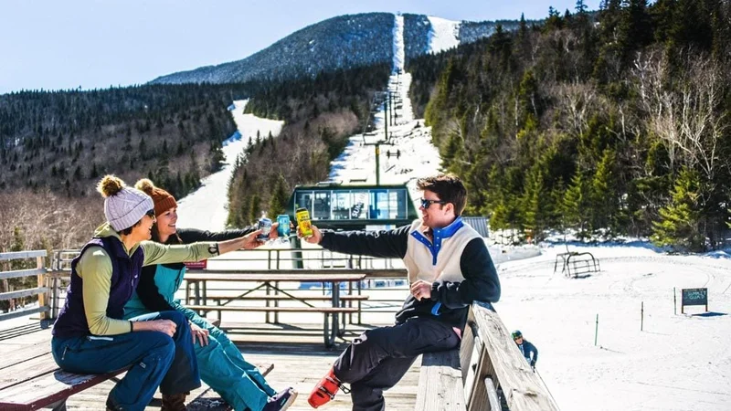 Image description: Group of friends enjoying drinks with view of ski lift at Sugarbush Resort, Vermont.