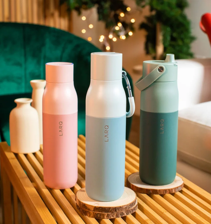 Group of LARQ Bottles in front of a tree