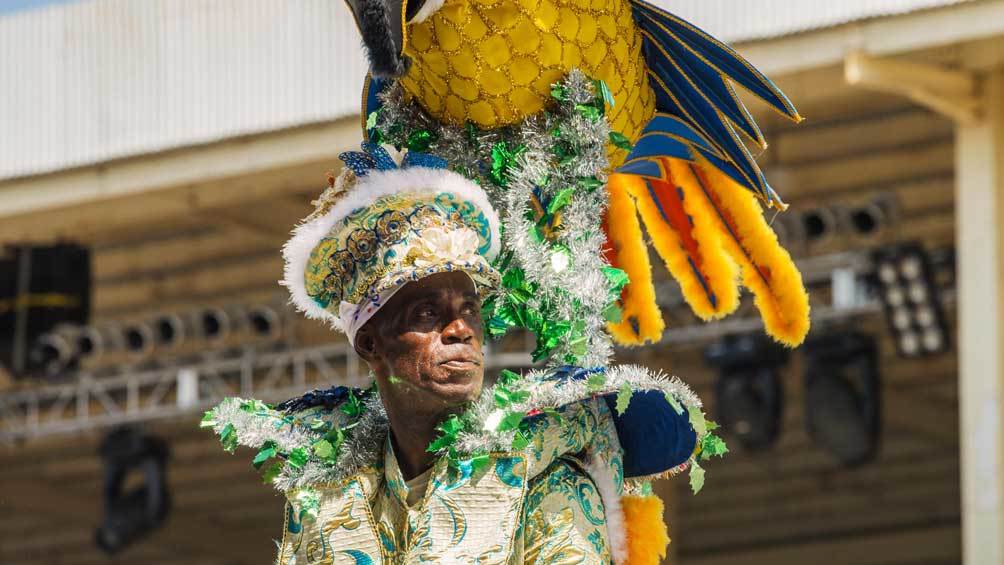 Image description: A man wearing costumes dancing at the Sambadrome during the Carnival celebration at Port of Spain, Trinidad and Tobago.