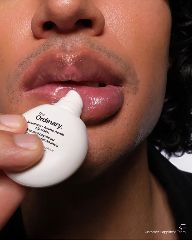 Kyle applying Squalane + Amino Acids Lip Balm
