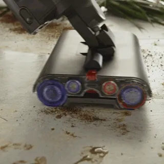 Dyson wet cleaner washing grime from a hard floor