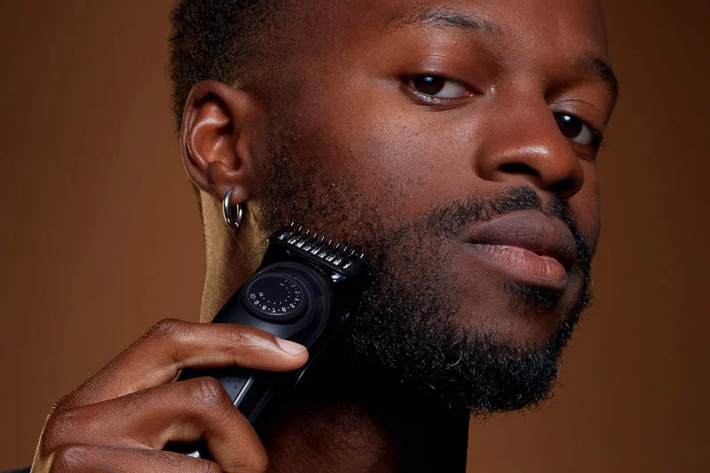 A black man shaving a beard