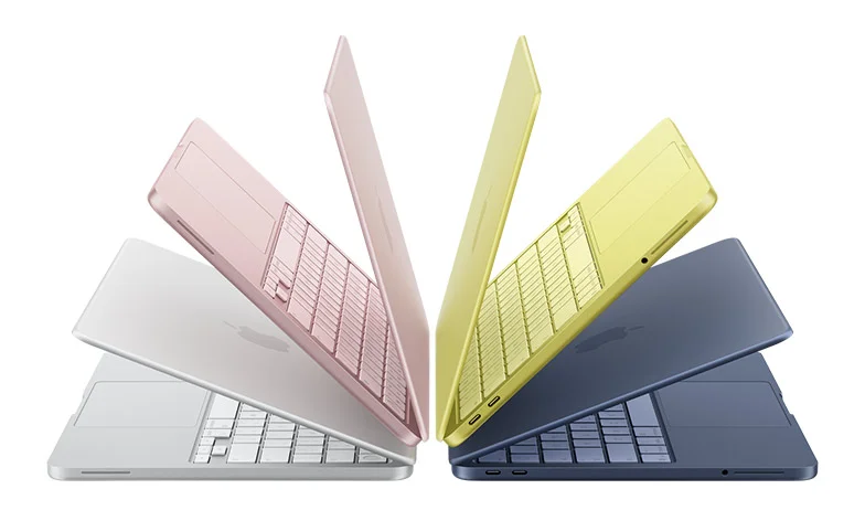 MacBook Neo laptops in silver, blush, citrus, and indigo colors, slightly open and arranged in an arch formation