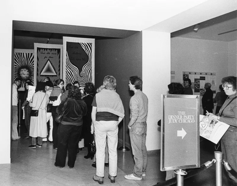 People standing in line to see “The Dinner Party” by Judy Chicago