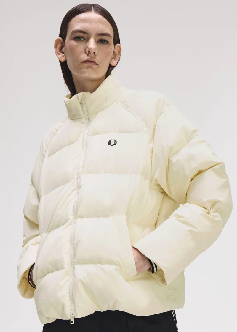 Female model wearing a Fred Perry Raglan Sleeve Padded Jacket in Ecru