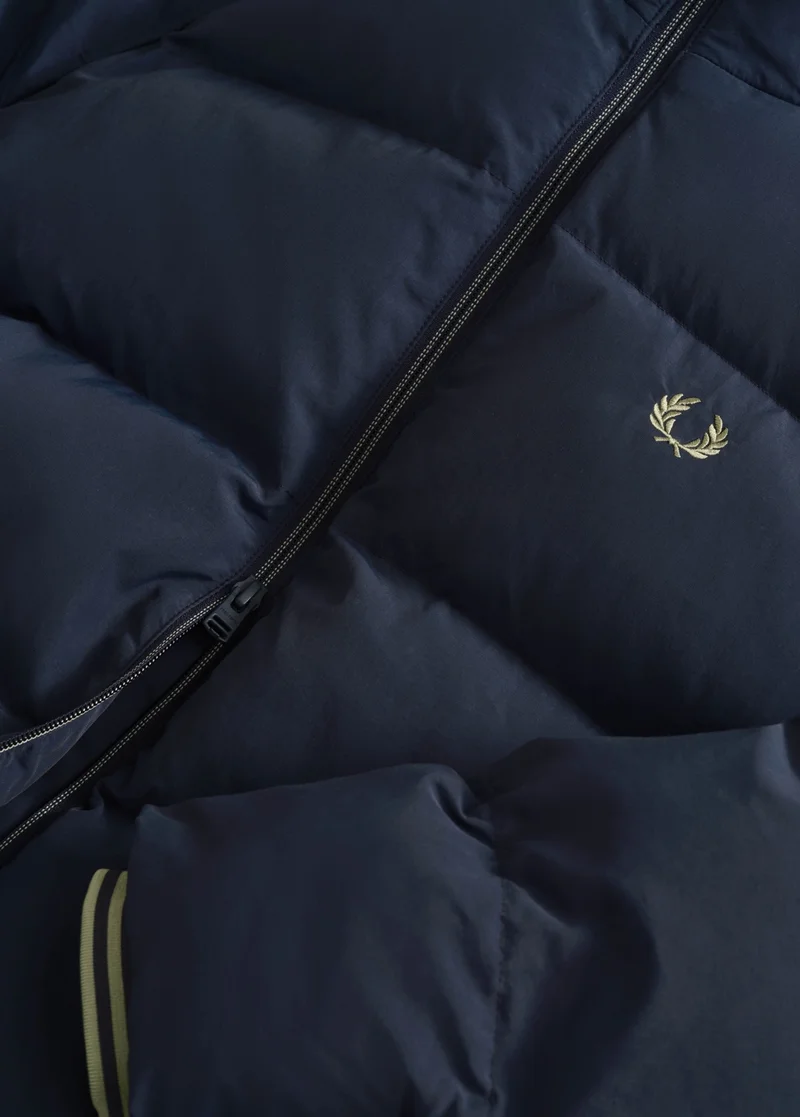 Close up of a Fred Perry Raglan Sleeve Padded Jacket in Dark Airforce