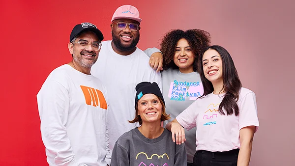 Models pose with SFF25 hats, beanies, long and short sleeve t-shirts, and sweatshirts.