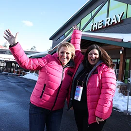 Two volunteers at the Festival pose in front of The Ray.