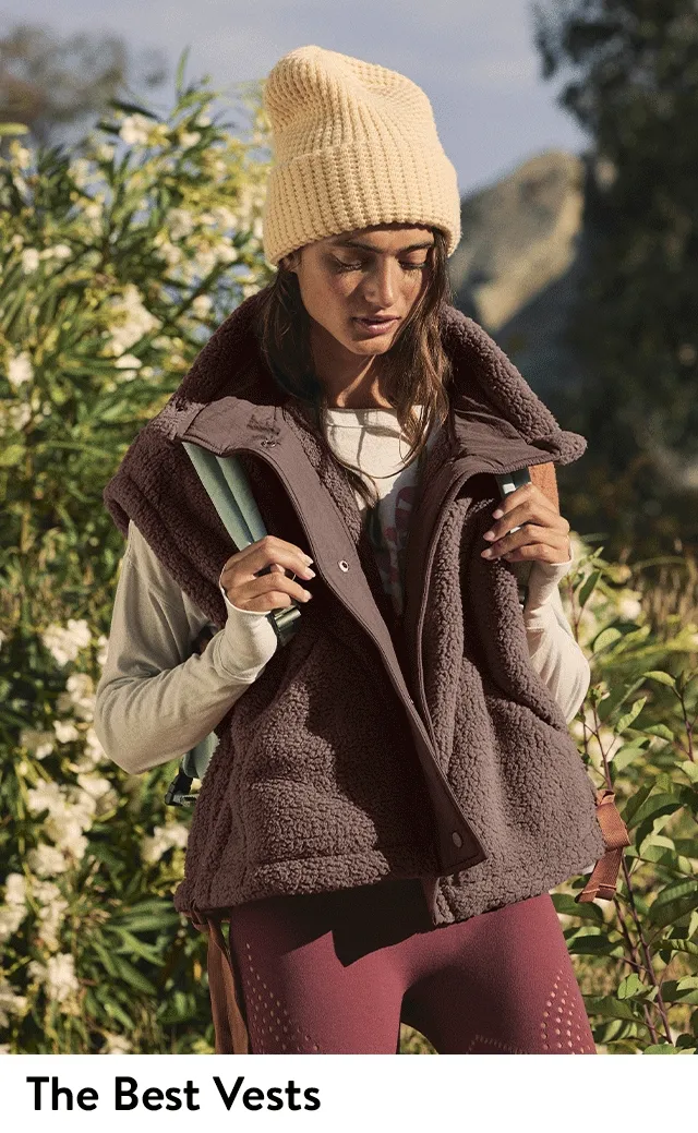 A woman wearing a fleece vest. A woman wearing a puffy vest.