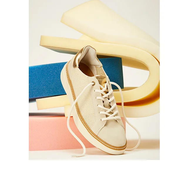Off-White women's Cane Sneaker positioned in front of colorful foam. Shop Sneakers.