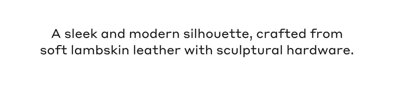 A sleek and modern silhouette, crafted from soft lambskin leather with sculptural hardware.