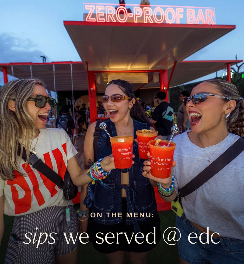 on the menu: sips we served at edc. friends giving cheers with non-alcoholic beverages at a music festival.