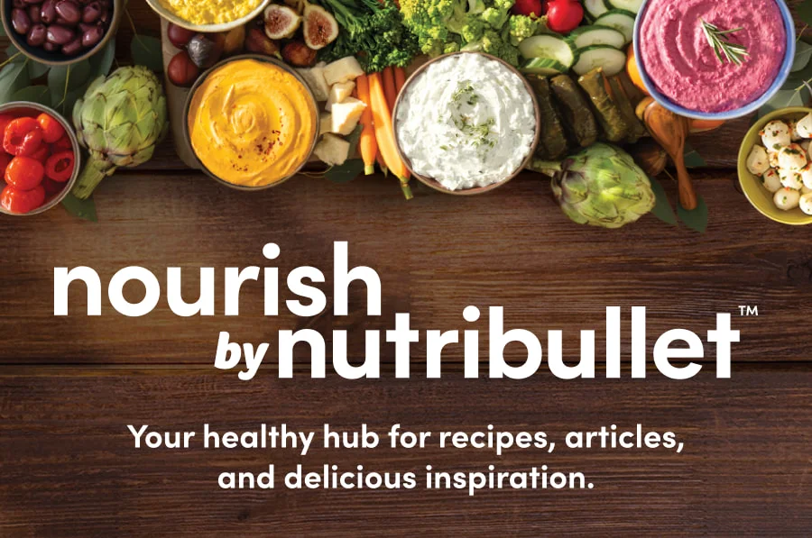 A vibrant display of fresh ingredients like fruits, vegetables, and herbs surrounding a nutribullet blender, highlighting the brand's focus on healthy, nutrient-packed recipes.
