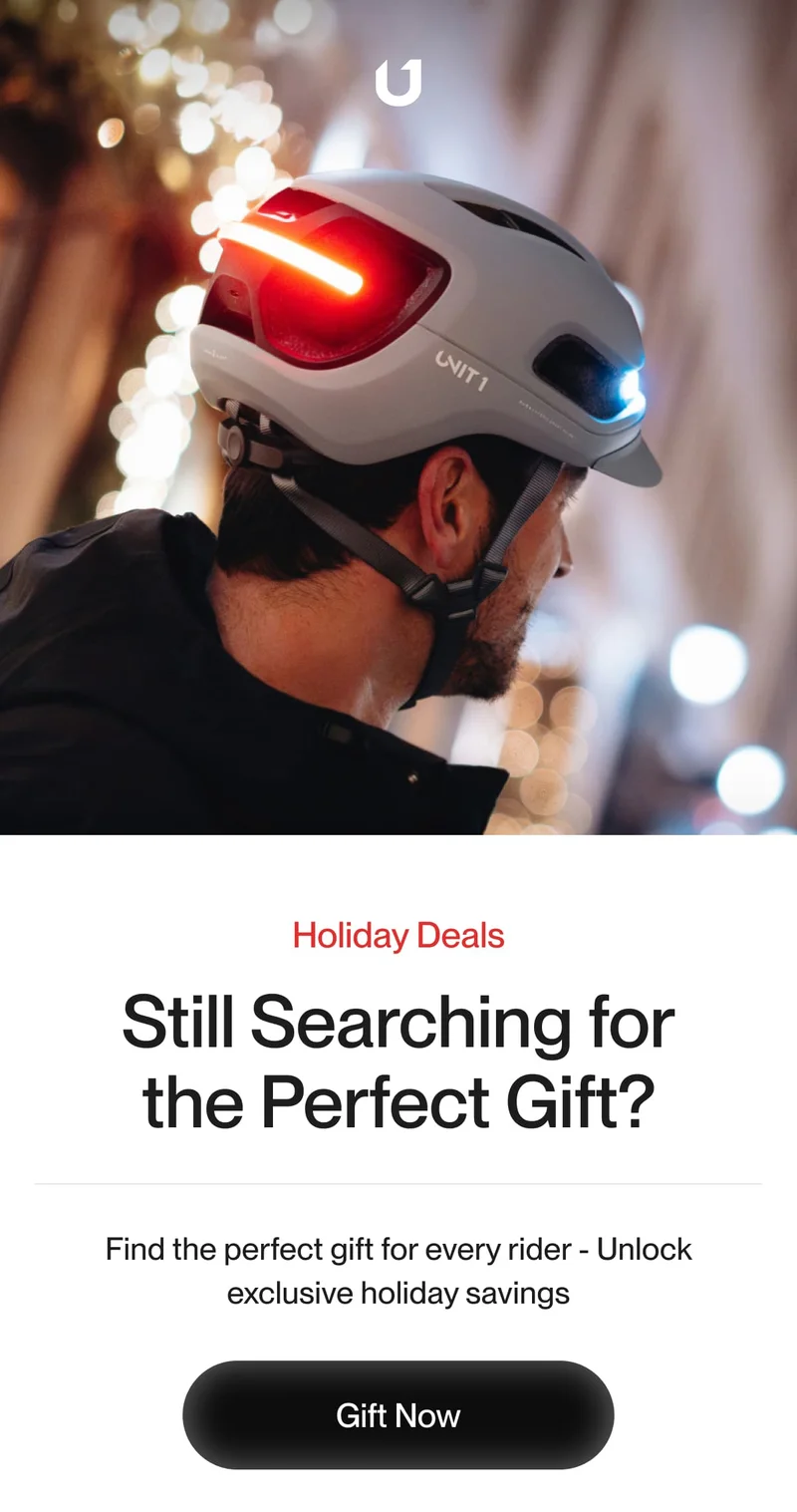 Urban cyclist with a smart helmet featuring integrated front and rear lights. Holiday deals for the perfect rider gift.