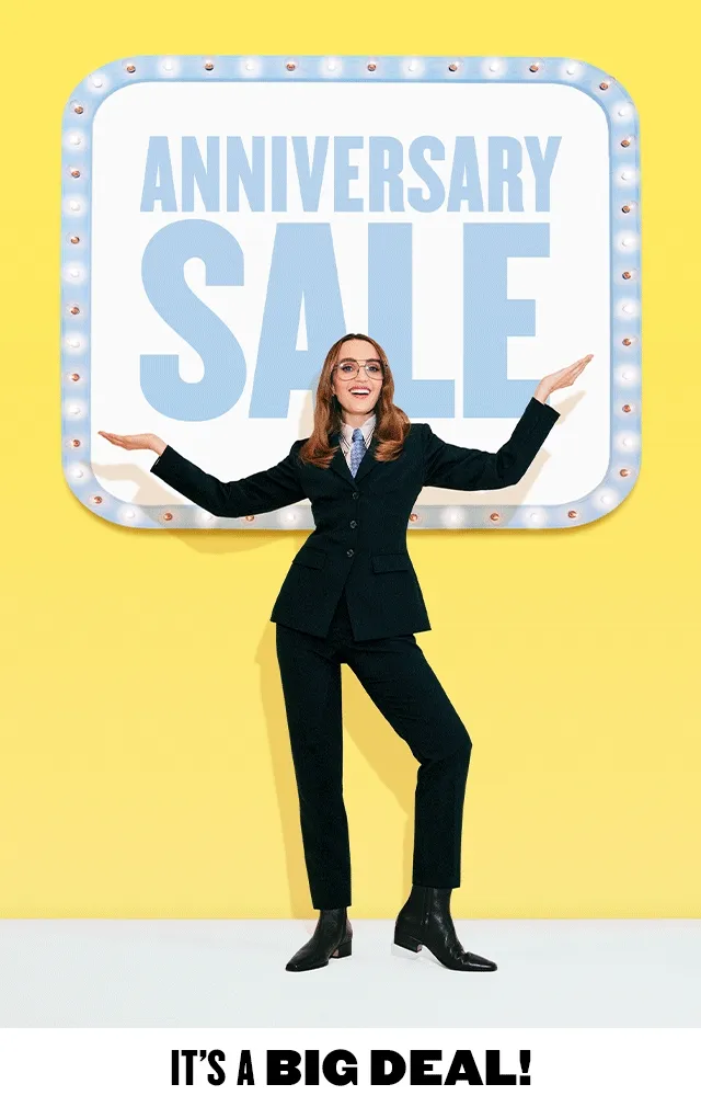 Anniversary Sale: It's a big deal! Chloe Fineman in front of an Anniversary Sale sign.
