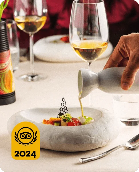 Image Description: Close-up of a person pouring olive oil onto an appetizer at Restaurante 1621, a fine-dining restaurant in Cartagena, Colombia