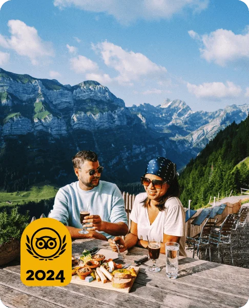 Image Description: A couple enjoying a charcuterie board at an outdoor restaurant in the Swiss Alps