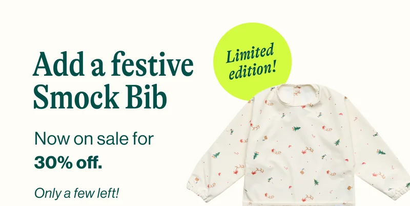Add a festive Smock Bib. Now on sale for  30% off. Only a few left! Shop Now