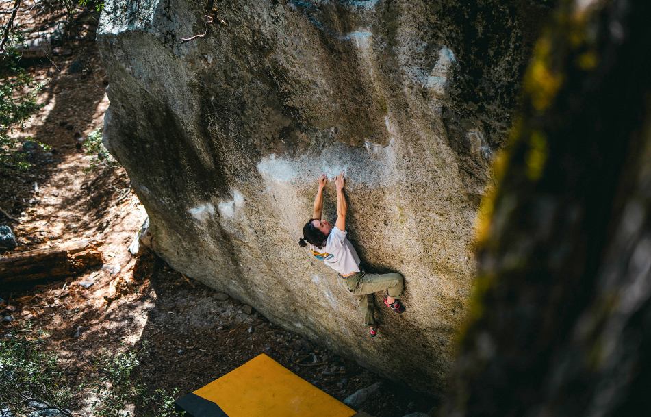 A climber on a difficult boulder problem.