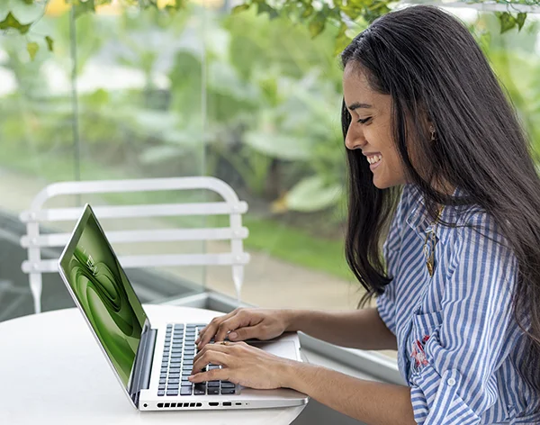 Young Businesswoman Using Laptop at an Outdoor Cafe
