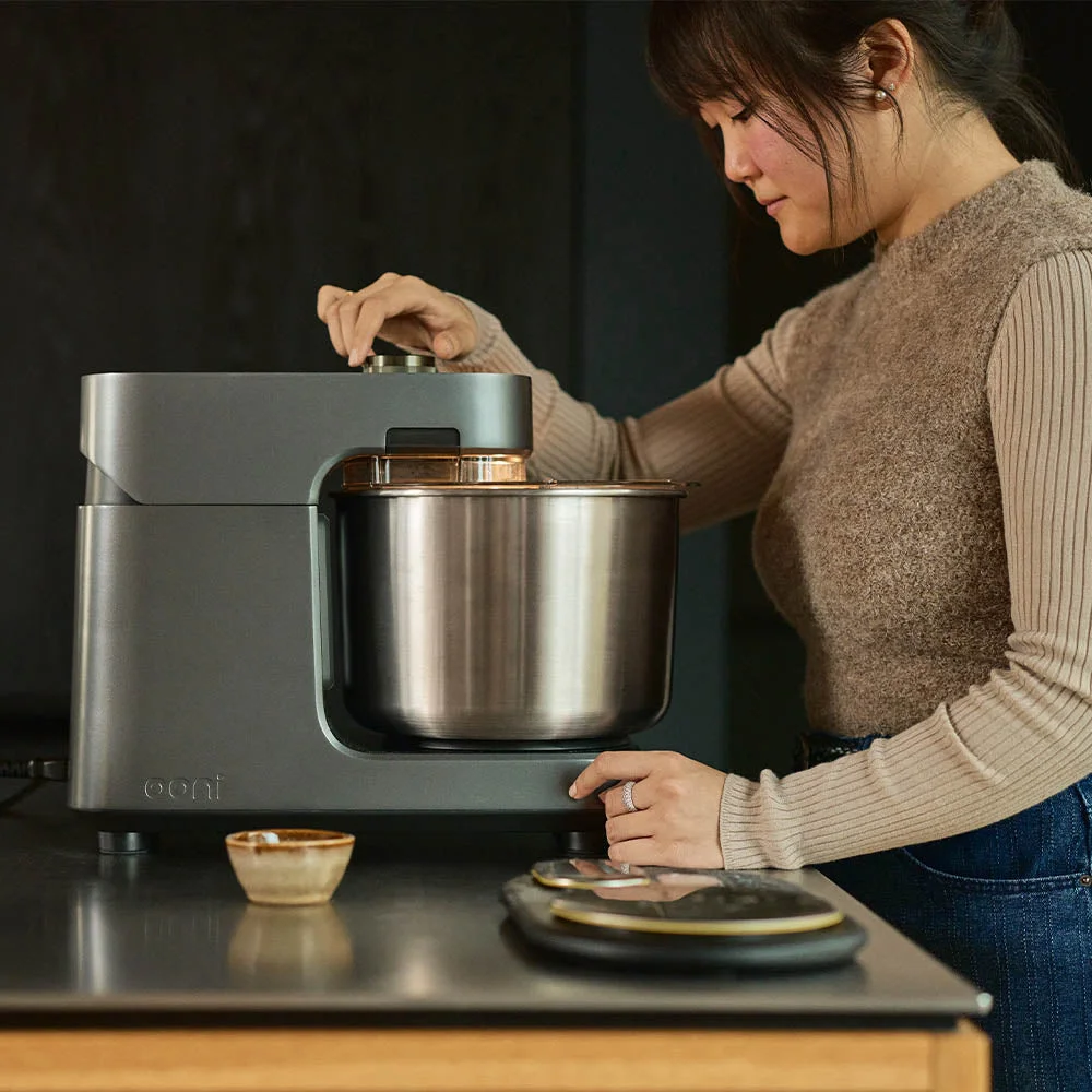 A woman playing with the dials on the Halo Pro Spiral Mixer