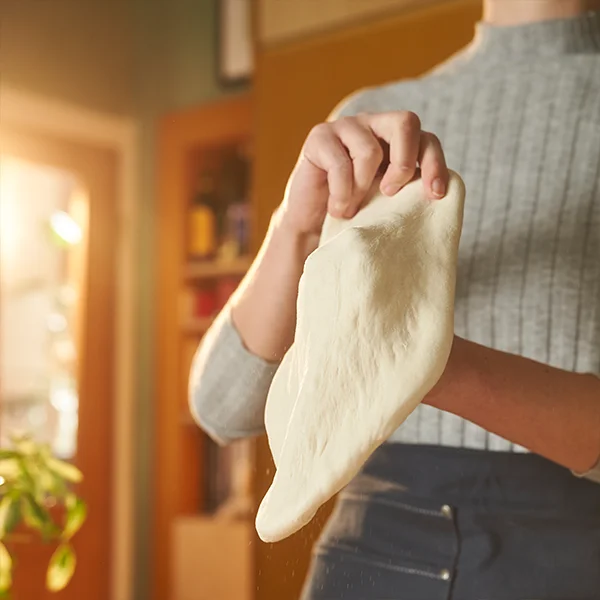 A dough ball being stretched