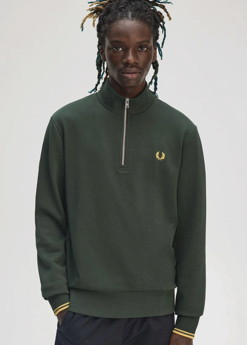 Black model wearing a Fred Perry Court Green Twin Tipped Sweatshirt