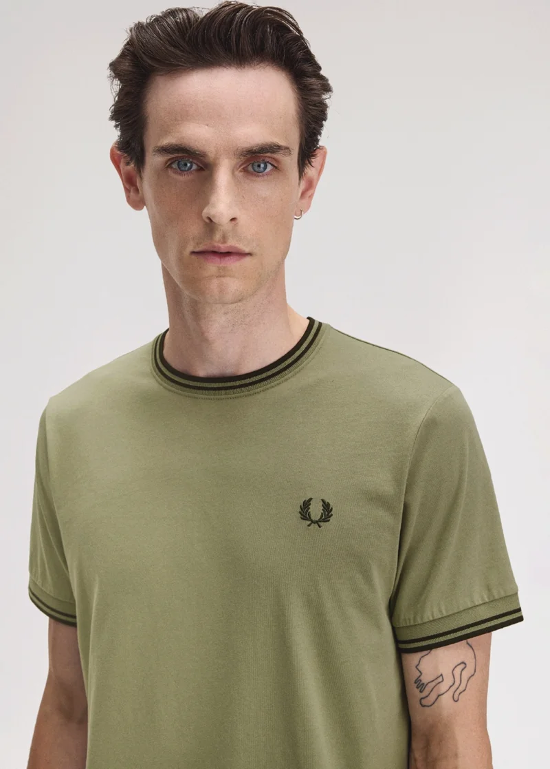 Male model wearing an Olive Mint and Night Green Twin Tipped Fred Perry T-Shirt