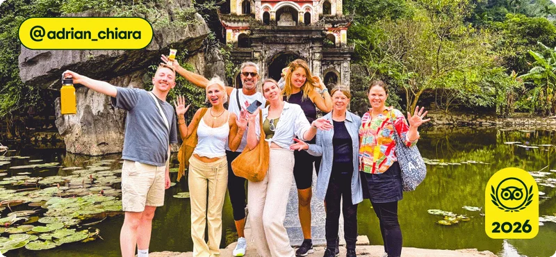 Image Description: A group of people posing in front of an ancient building in the jungle.