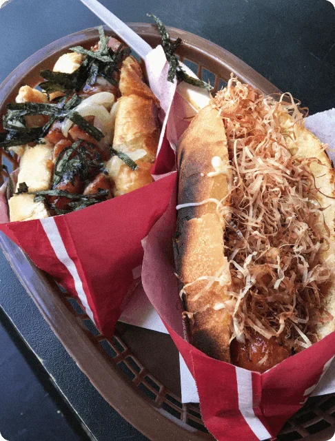Image Description: A close-up shot of a chicken floss hotdog and a seaweed mayo hotdog with generous toppings