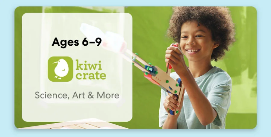 Young child smiling while working on a science experiment from KiwiCo Labs. Hands-on STEM learning for ages 6–9