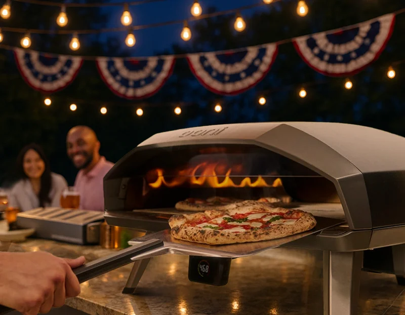 Koda 2 Max cooking two pizzas at once, with USA bunting in the background