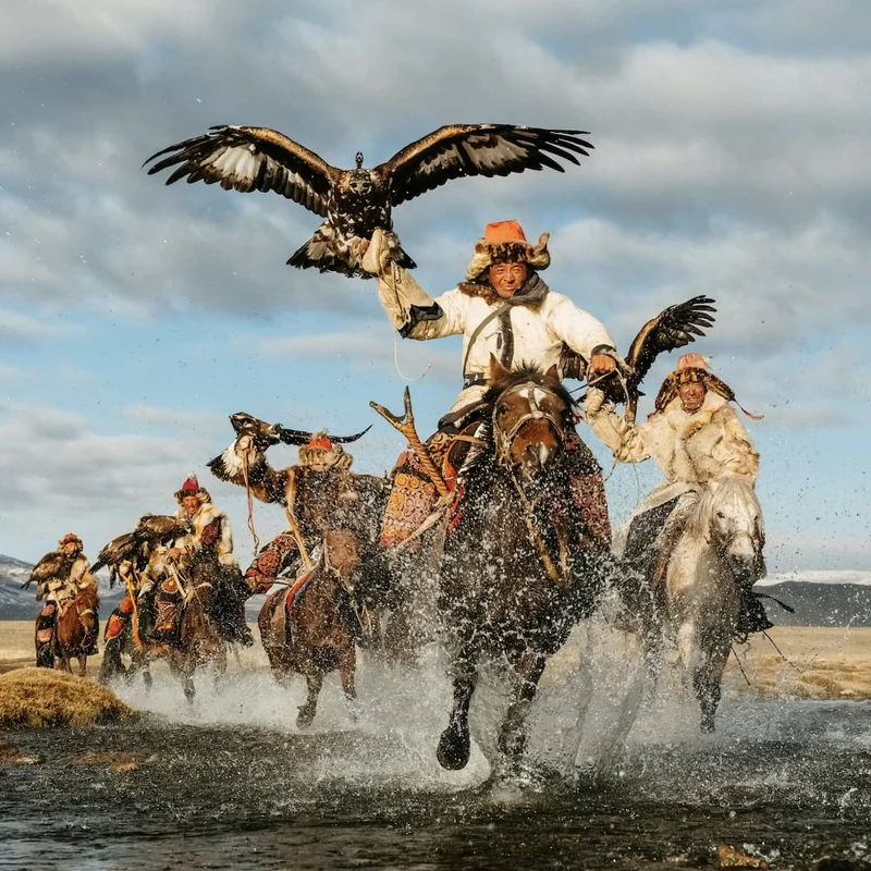 an image of a man riding a horse with a bird on his arm