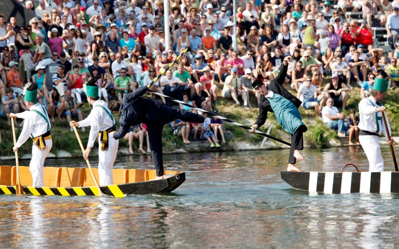 Ulm's fisherfolk jousting imaginatively presents the city's history through characters like the police (left) and the ‘Krettaweber’ (right), the infamously bad-mouthed vegetable seller.