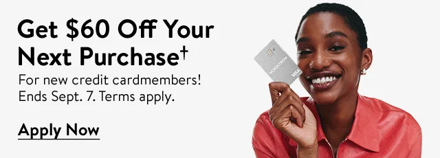 Woman smiling and holding a Nordstrom Visa® credit card.