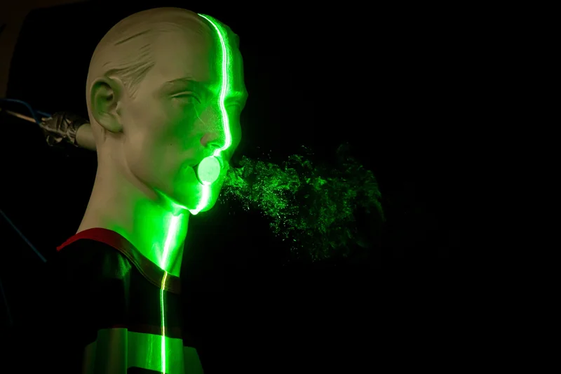 Viruses may make us cough to spread itself, as illustrated by this simulated spray from coughing in Berlin in 2020. But what about when that virus no longer detectable, but we’re still coughing?