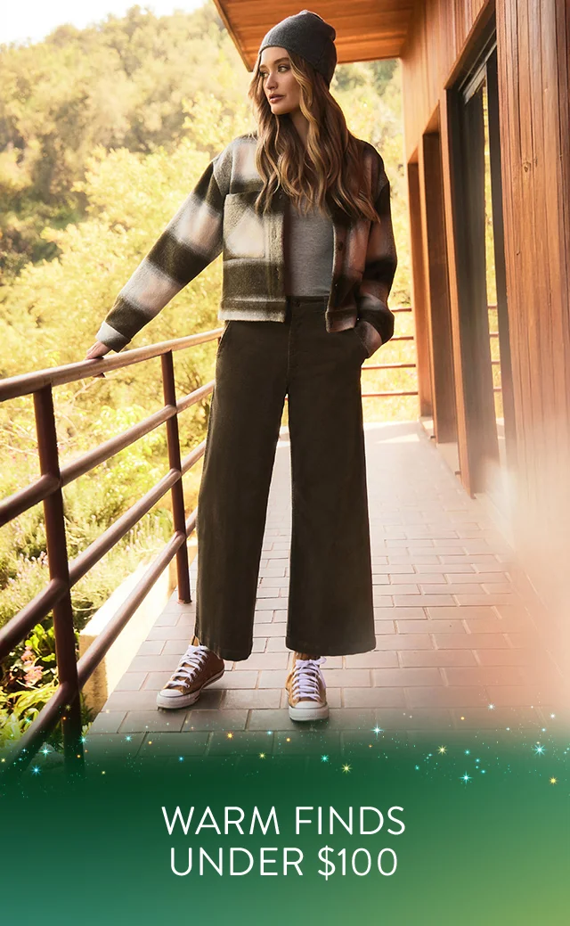 A woman wearing a printed jacket with wide-leg pants.