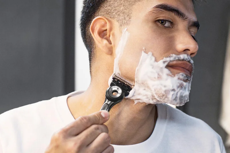 Man shaving his face with Gillette razor Man shaving his face with Gillette razor