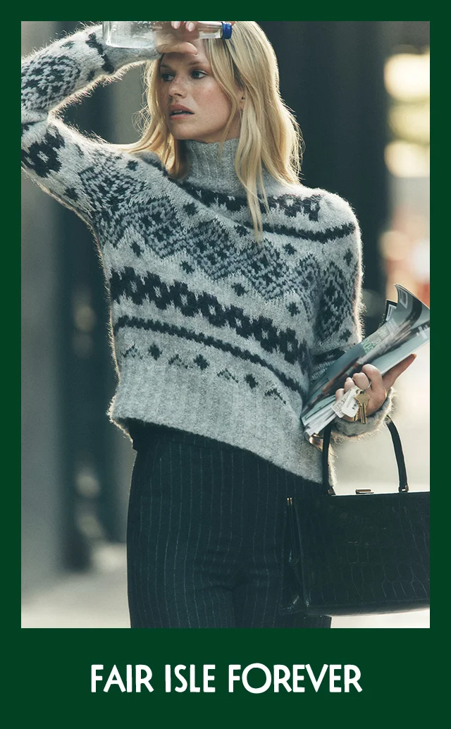 A woman wearing a grey Fair Isle sweater.