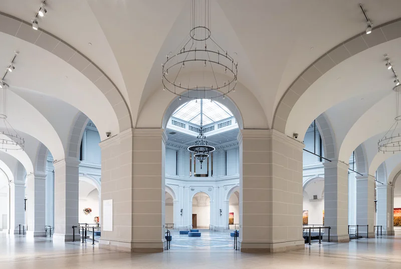 Columned archways in front of a light-filled court
