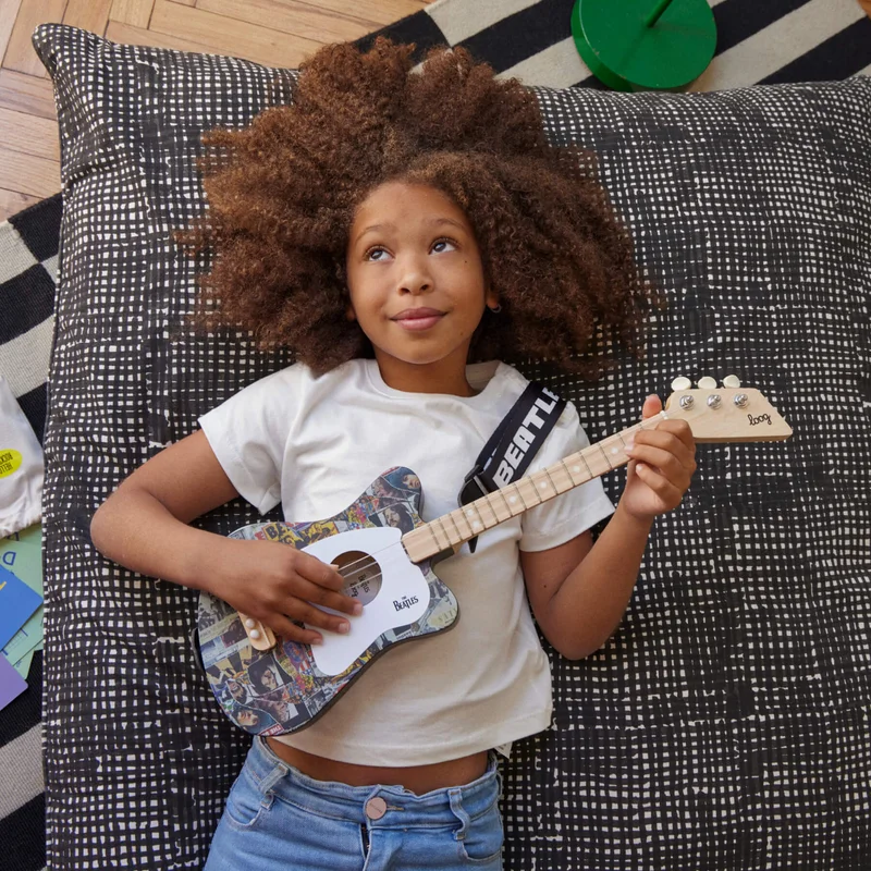 girl playing a beatles + loog guitar