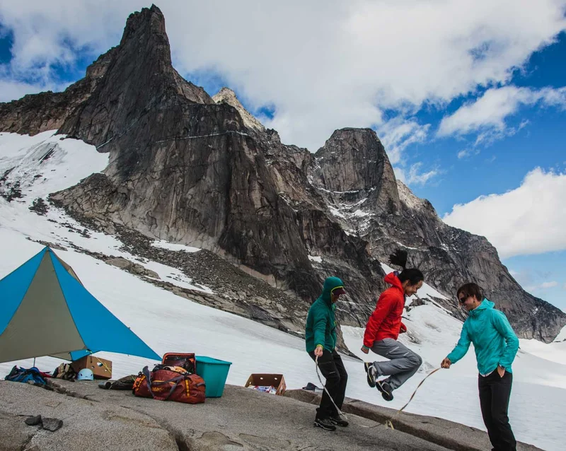 A team of climbers plays jumprope at a high mountain camp.