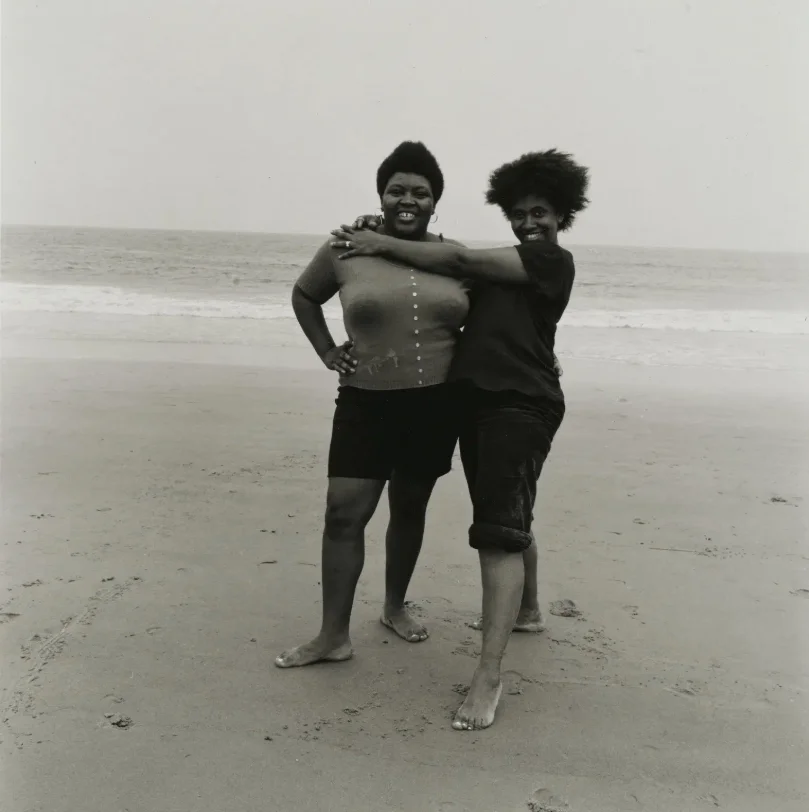 Sepia photograph of two people hugging on the beach