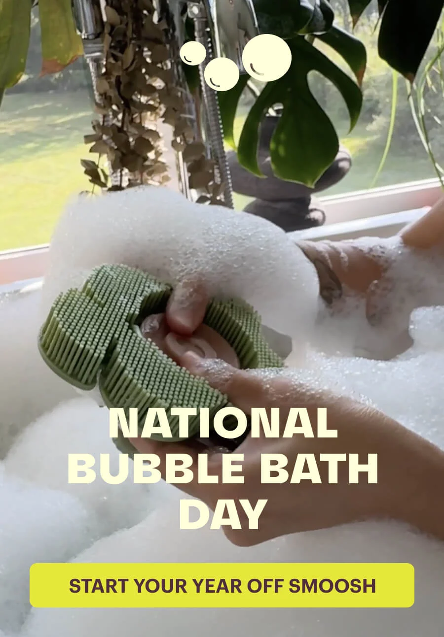 Women in a bubble bath with a smoosh scrubber