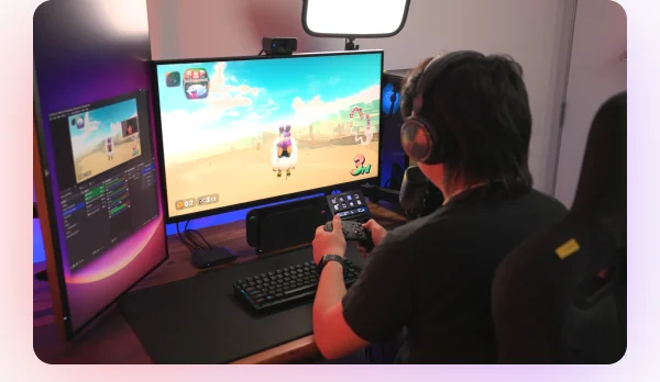 Person playing a computer game at a desk with Elgato products.
