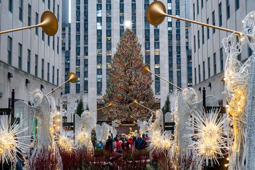 Rockefeller Center Christmas tree with decorative angels and lights in the foreground