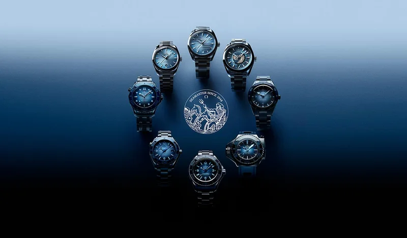 Collection of OMEGA Seamaster watches with dark blue dials arranged around the Seamaster logo.