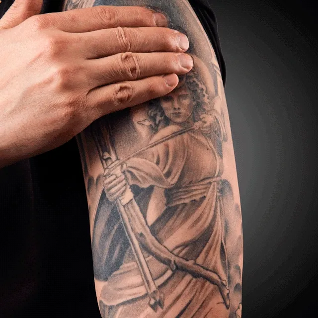 man rubbing gel on arm with tattoo